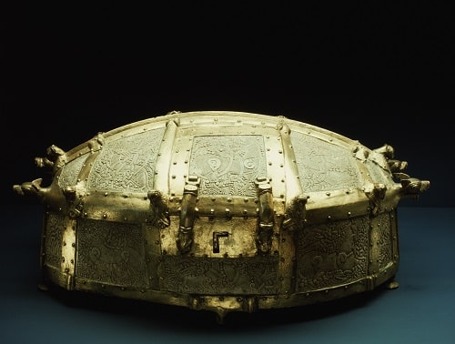 A replica of a Viking casket. Gilded bronze and ivory. The intricately carved panels depict mythic beasts entwined in heavy patterning. The casket is banded with gilded bronze, animal and bird heads decorate the lip of the lid. National Museum, Copenhagen, Denmark. --- Image by © Werner Forman/Werner Forman/Corbis