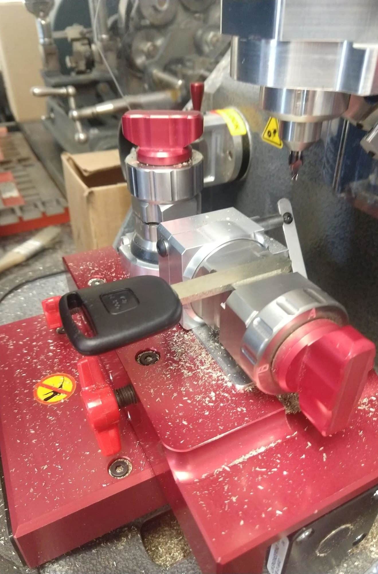 A locksmith making a new car key